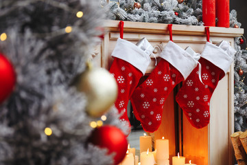 fireplace with christmas stockings in festive room interior