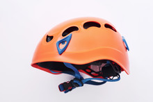 Side View. Isolated Photo Of Climbing Equipment - Orange Colored Protective Helmet
