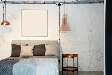 Wall Mural - Modern interior of bedroom with stylish furniture, bed, table and gold lamp. Industrial style with white brick wall with blank frame with mock up. Copy space.