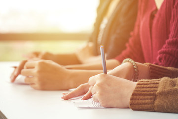 Woman hands writing on the table. Education and seminar concept.