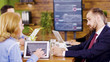 © DC Studio - Middle age female team lider standing near the table giving direction to her young coworker