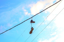 Sports Shoes Dangling On Electric Wires