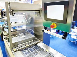 Canvas Print - Plastic containers on conveyor at food factory for packing