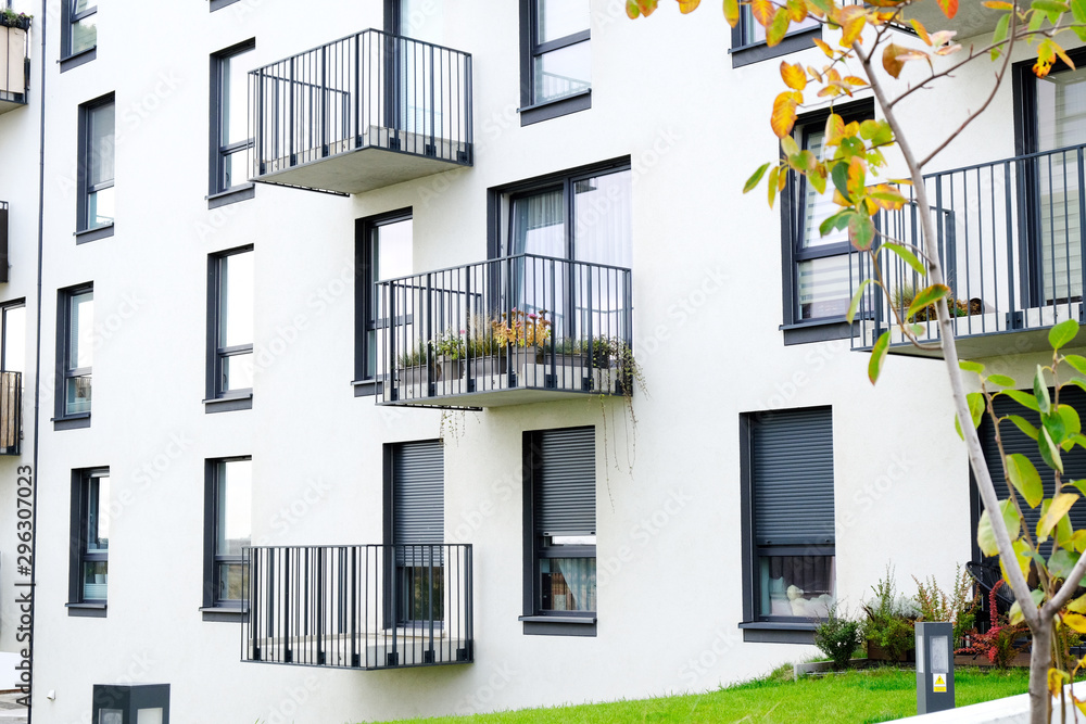 Exterior of a modern  apartment buildings with balcony and white walls. - obrazy, fototapety, plakaty 