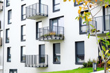 Fototapeta Sypialnia - Exterior of a modern  apartment buildings with balcony and white walls.
