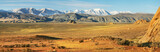 Fototapeta  - Typical landscapes of Mongolia. Snow on the peaks, desert mountain slopes and valleys.