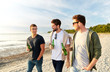 © Syda Productions - friendship and leisure concept - group of happy young men or male friends toasting non alcoholic beer walking along summer beach