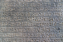 Egyptian Hieroglyphs On The Wall. Ancient Letter Pattern In Cold Grey Colors
