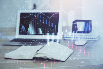 Stock market graph and table with computer background. Multi exposure. Concept of financial analysis.