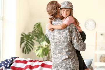 Happy military man with his daughter at home