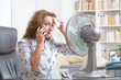 © Monika Wisniewska - Woman suffers from heat in the office or at home