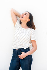 Wall Mural - cheerful older woman laughing with hand in hair by white background