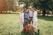 © hetmanstock2 - Family in a summer park. People walking with a dog. Parents with a two daughters