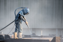 Sand Blasting Process, Industial Worker Using Sand Blasting Process Preparation Cleaning Surface On Steel Before Painting In Factory Workshop.