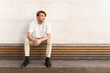 © VITTA GALLERY/Westend61 - Barcelona, Spain. Business man outdoors. Casual, job, outdoor office, digital, digital nomad, millennial, young man, daytime, work, laptop, technology