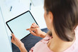 © Bartek Szewczyk/Westend61 - Overhead view of woman using tablet in office