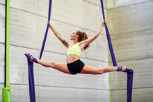 Young Woman Doing Aerial Silk In An Exercise Room