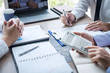 © Ngampol - Business team discussion on meeting to planning investment trading project and strategy to investor of deal on a stock exchange with partner, financial and accounting concept, collaborative teamwork