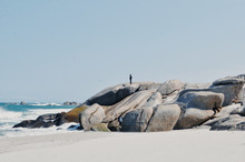 Man Standing On Rocks At Beach