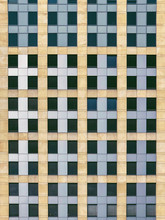 Grid Of Dark Windows On Highrise Facade