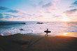 © Luis Ortega - Silhouette of man carrying surfboard on beach at sunset