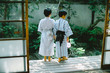 © Taishi Arashida - Rear view of siblings in kimono standing on patio