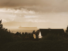 Houses With Sea And Industrial Ship In Background