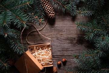 Wall Mural - A frame of fir branches and an open gift paper box tied with twine. Christmas card blank.
