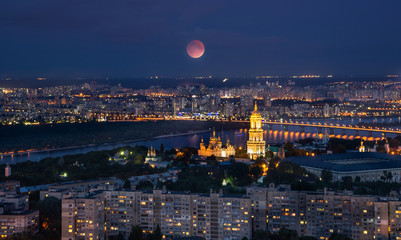 Fototapete - Kyiv cityscape at night with full moon, Ukraine