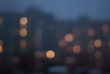 © natagolubnycha - Blurred background of evening cityscape with luminous windows