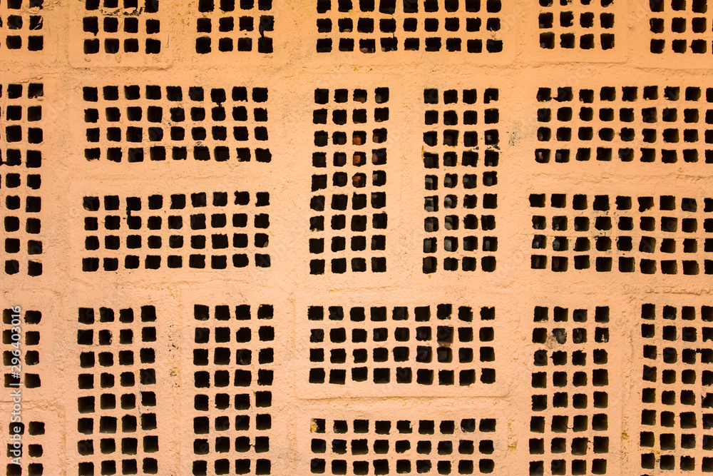 old gray beige wall with rectangular patterns and black cells. rough ...