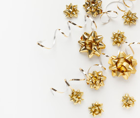 christmas or new year composition with gold sparkling ribbon decorations on white background. flat l