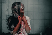 A Woman Is Brutally Murdered By A Bag Over Her Head. Feeling Tortured And Needing Help, Halloween Murder Concept.