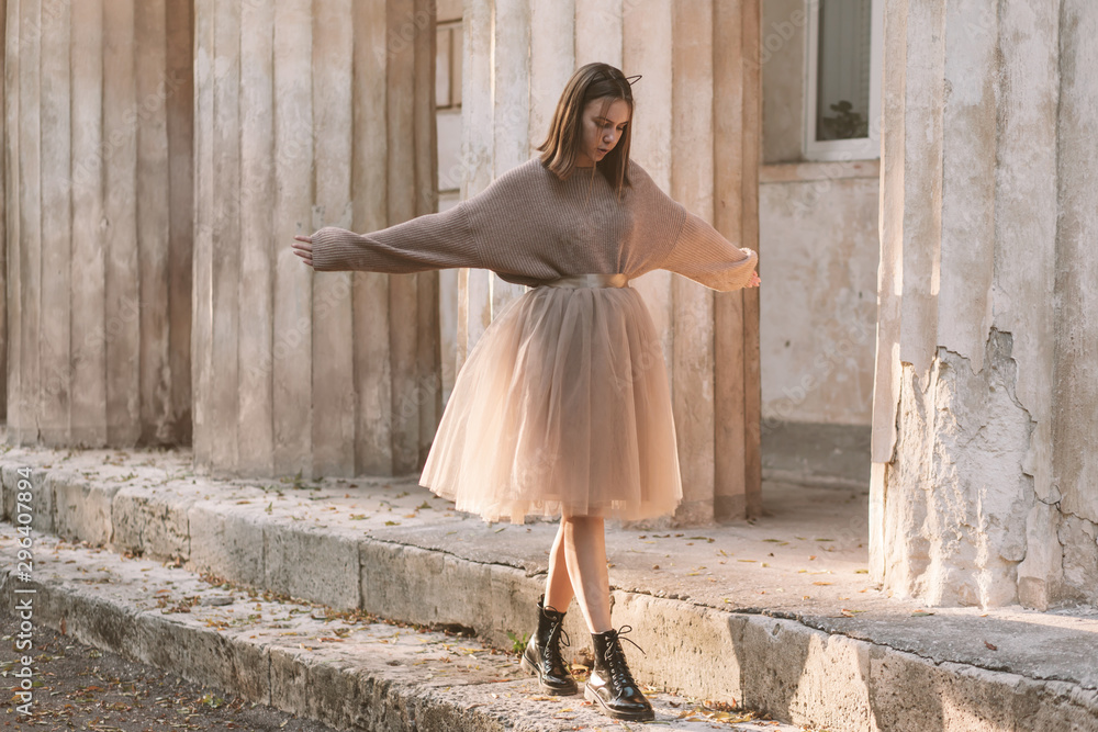 Teen girl in brown tulle skirt and autumn sweater - obrazy, fototapety, plakaty 