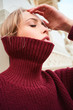 © Anton - Close up beautiful blond girl in sweater sensually posing outdoor