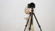 © MEDIAIMAG - Adorable baby child playing with video camera on tripod