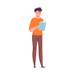 © greenpicstudio - Young man standing and reading a book with the blue cover. Vector illustration in a flat cartoon style.
