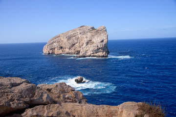 view of single rock in sea