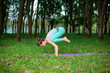 © Kate - A young sports girl practices yoga in a quit green summer forest, yoga assans posture. Meditation and unity with nature