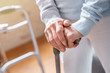 Close up of senior woman's hands holding walking stick