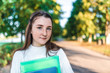 © byswat - teenager white sweater summer city, teenage girl schoolgirl, background trees road, warm sweater, hands notebooks books and folders, smiling happy, after lessons school institute free space for text.