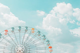 Fototapeta Tęcza - Retro pastel colorful ferris wheel of the amusement park in the blue sky  and cloud background.