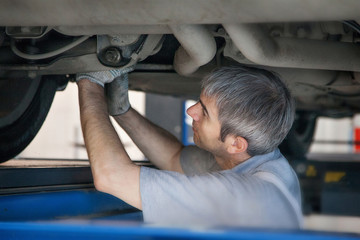 Wall Mural - Car repair and cleaning concept - car engine close-up, wiping parts under the hood