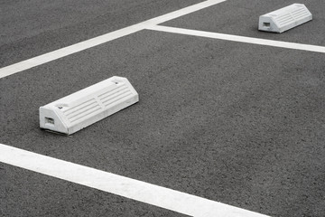 Empty parking spaces, white line and stop blocks.