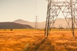 © ztony1971 - High voltage electrical pole in wide meadows at country side of South Island New Zealand with warm color tone of sunny day. Scenic view of sight seeing while driving around South Island street.