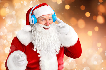 Wall Mural - Portrait of Santa Claus listening to music on color background