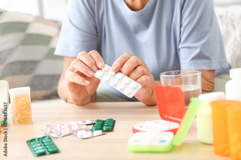 Elderly woman with medicines at home