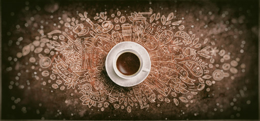 Coffee chalk illustrated concept on black board background - white coffee cup, top view with chalk doodle illustration about coffee, beans, morning, espresso in cafe, breakfast. Morning coffee