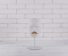 white mannequin head with mustache