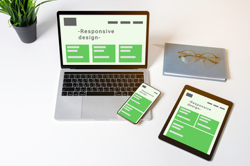responsive web design on laptop, tablet computer and mobile phone with clipping path from above.